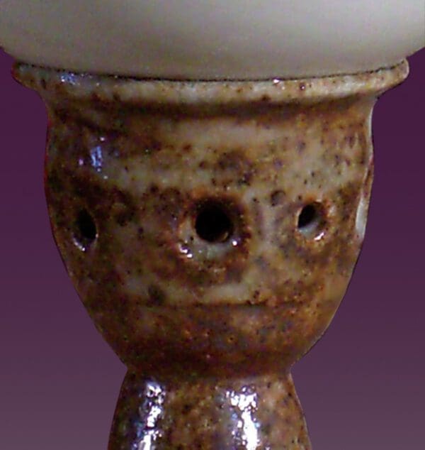 A close up of the face of a candle holder
