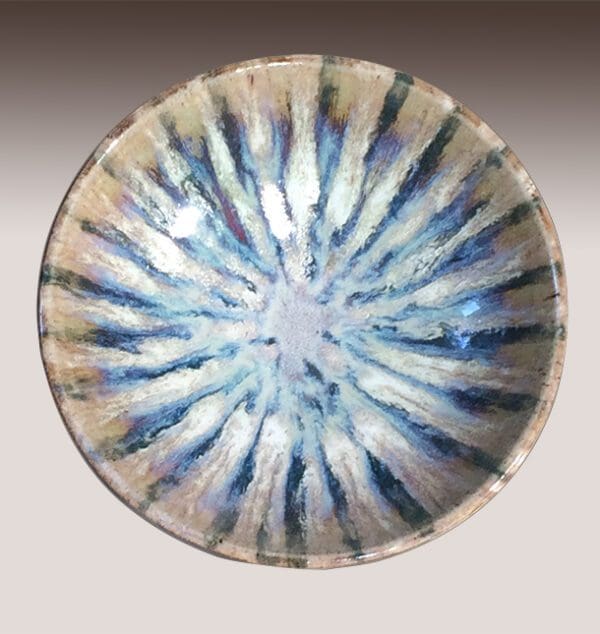 A bowl with blue and white stripes on it.
