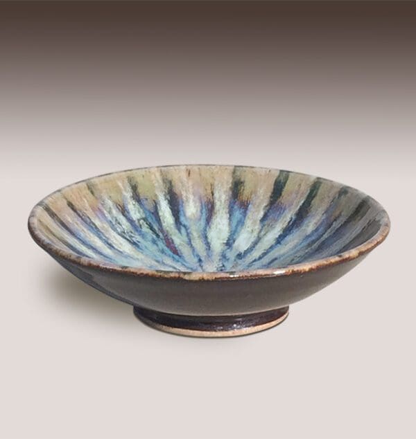 A bowl with blue and white stripes on it.