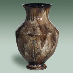 A brown vase with some black lines on it