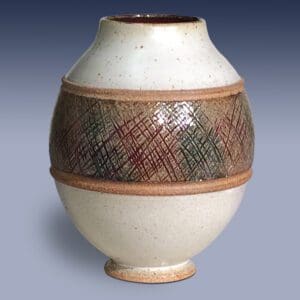 A white vase with brown and green stripes on it.